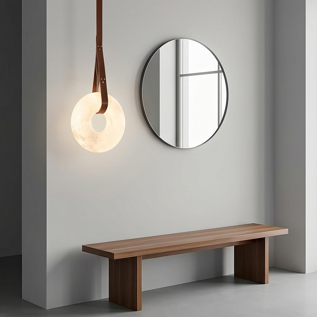 Alabaster Ring Pendant Light 4 Alt Text: Three illuminated alabaster ring pendant lights suspended by brown leather straps with brass hardware against a light grey background.