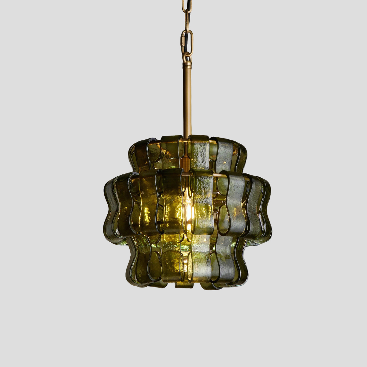 Vintage green glass chandelier 1 Wavy green glass pendant light with antique brass hardware turned on creating warm ambient glow