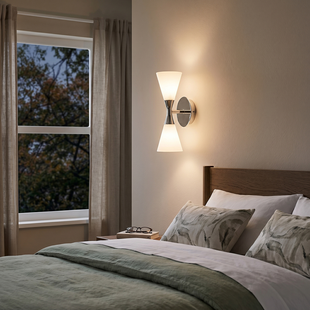 Mid-Century Modern Glass Wall Sconce 5 Modern chrome 2-light vanity sconce installed next to a bed as a master bedroom nightstand reading light.