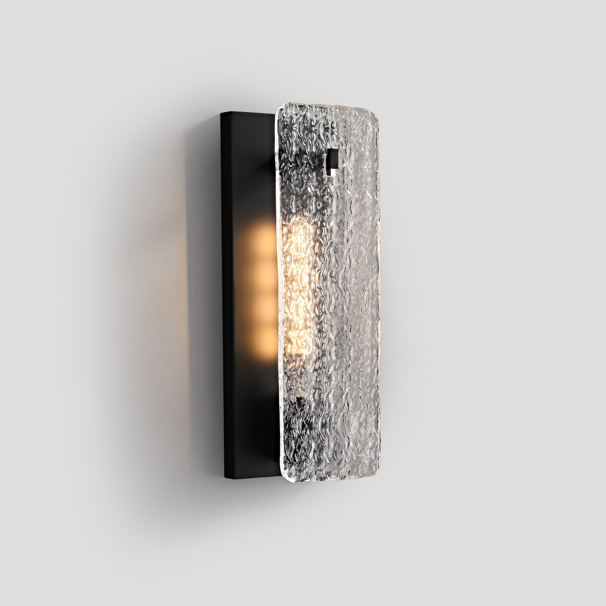 Modern Wall Sconce Lighting 1 Lifestyle shot of a contemporary matte black sconce rendering warm illumination.