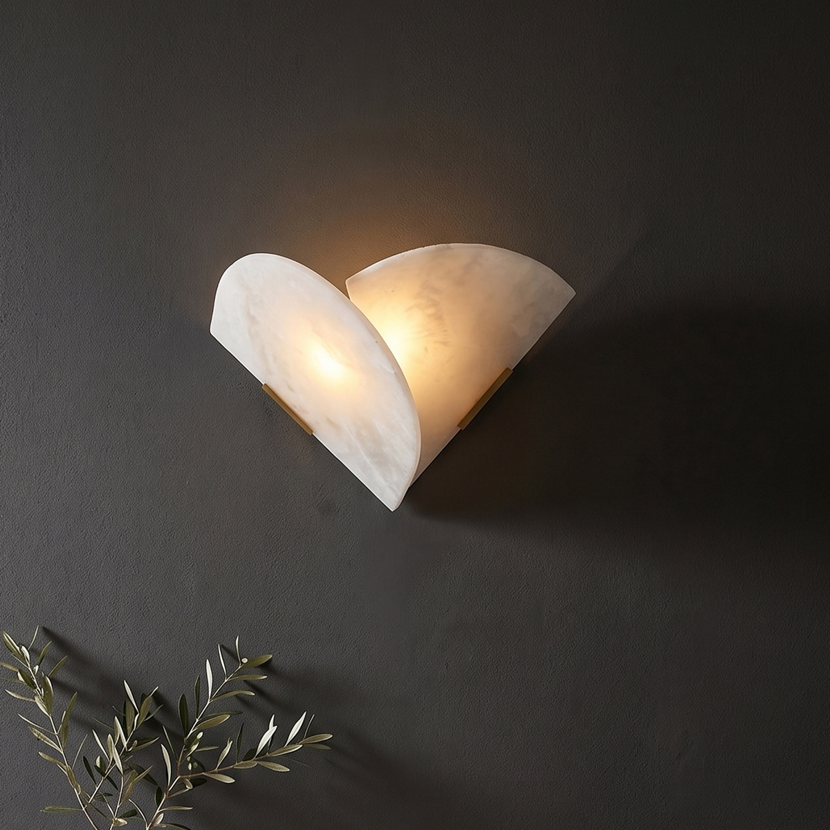 Modern Alabaster Wall Sconce 6 Elegant alabaster wall sconce glowing brightly against a dark textured luxury accent wall.