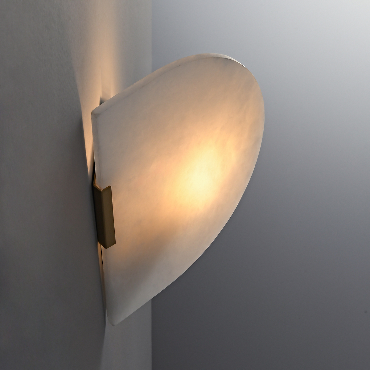 Modern Alabaster Wall Sconce 4 Profile close-up of a minimalist alabaster wall lamp mounted flush against a contemporary wall.