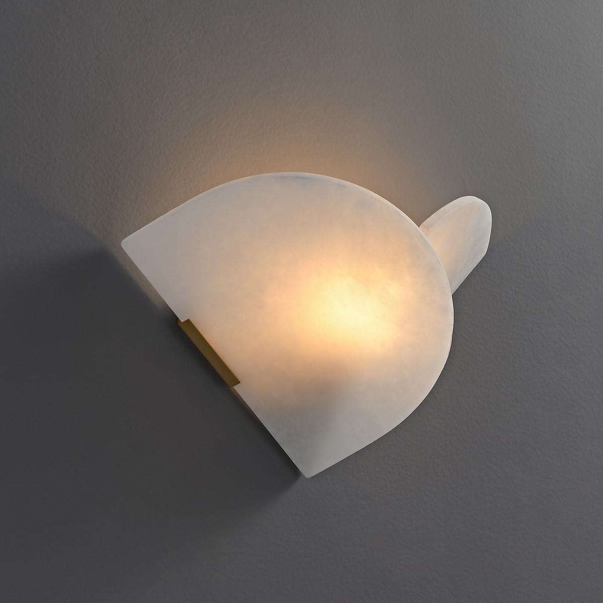 Modern Alabaster Wall Sconce 3 Side view of a sculptural overlapping alabaster disk wall sconce showing translucent stone texture.