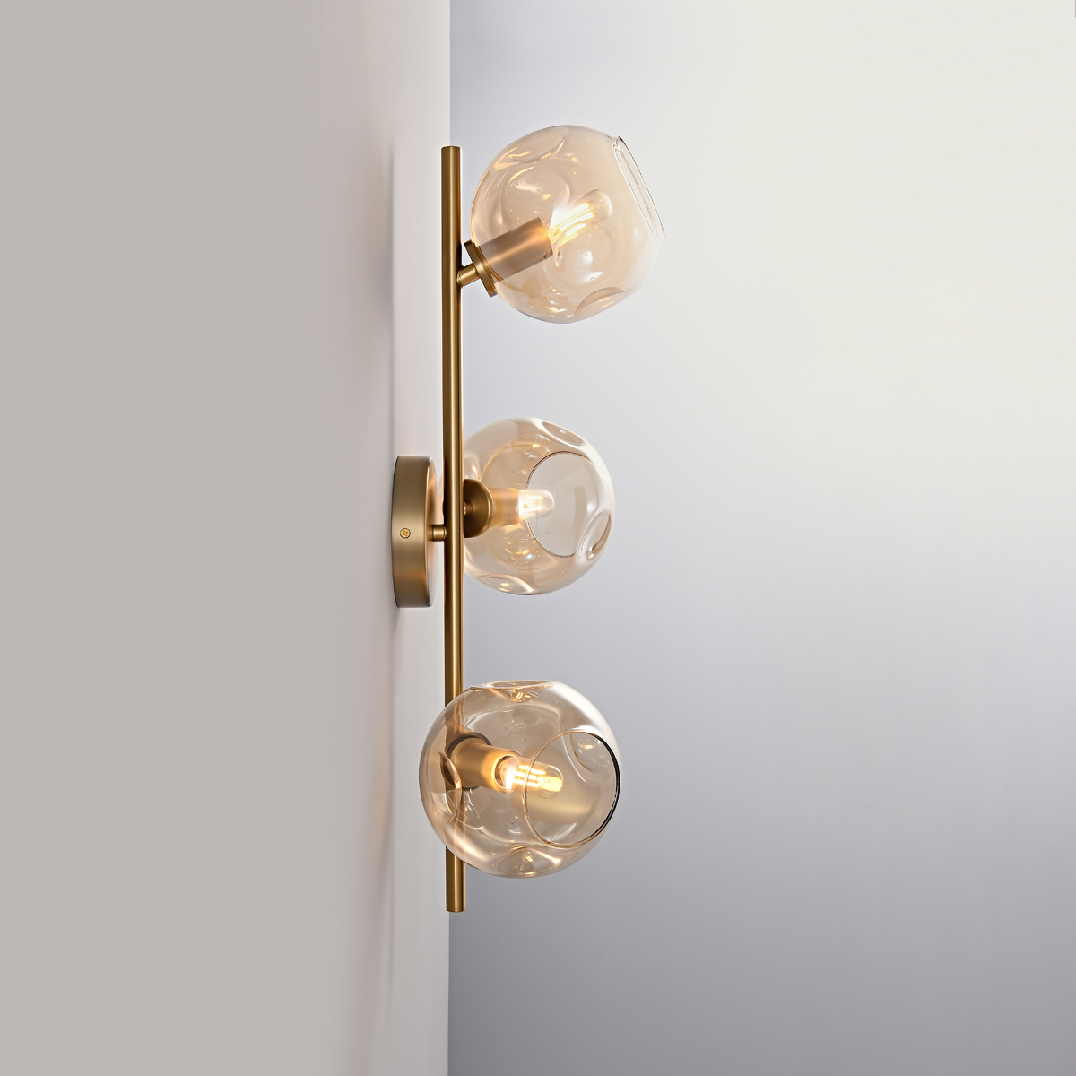 3-Light Modern Brass Wall Sconce 3 Side profile of the 3-light brass wall sconce showing the mounting plate.