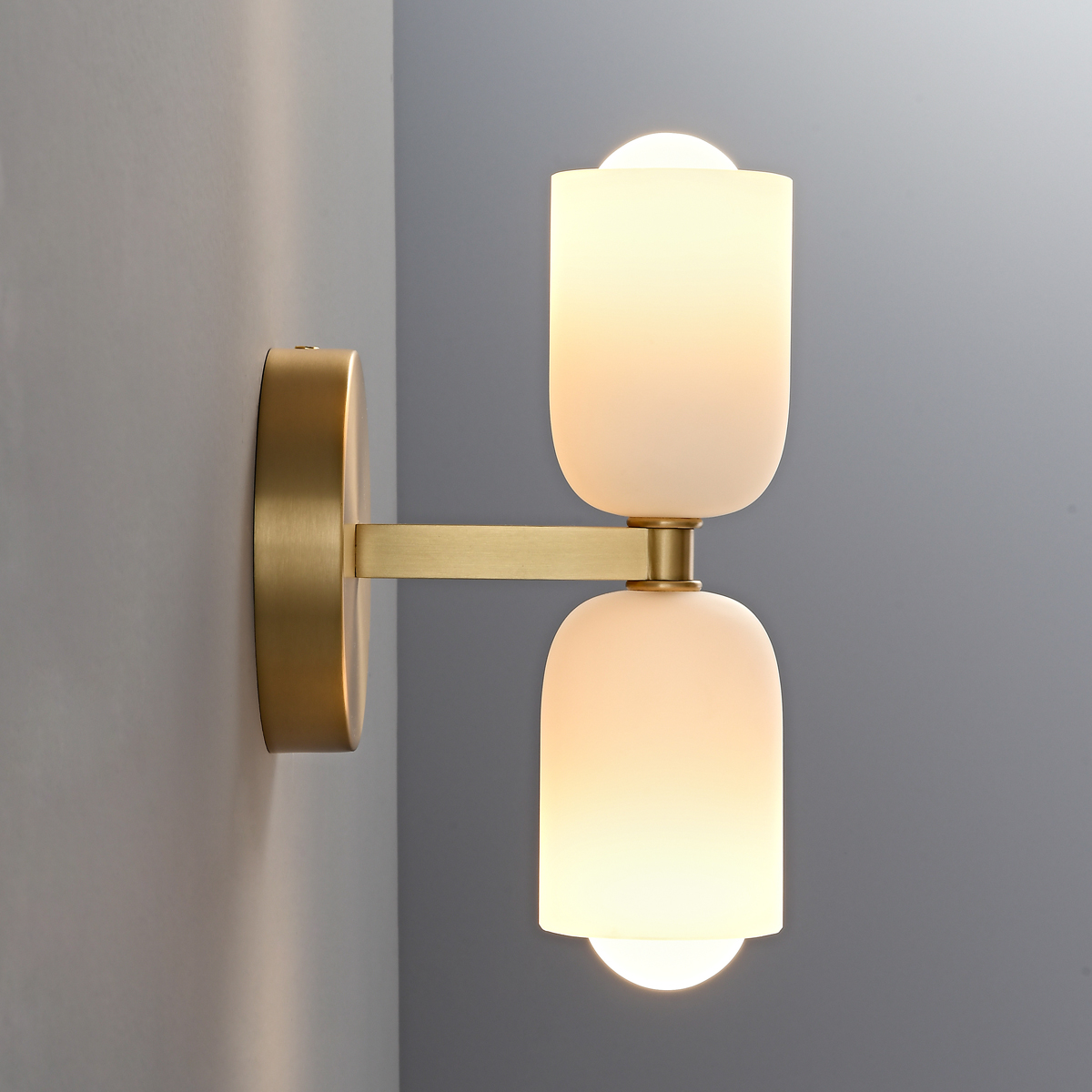 Mid-Century Modern Brass Wall Sconce 2 Side angle view of a gold double shade wall lamp highlighting the brass finish mounting arm.