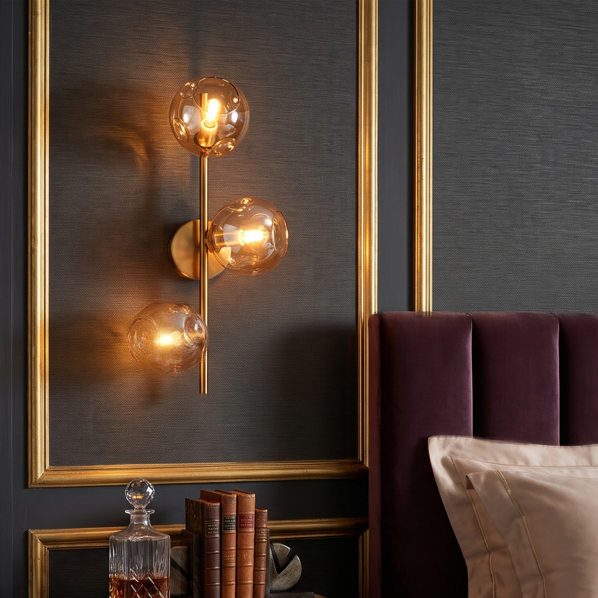 3-Light Modern Brass Wall Sconce 5 3-light brass wall sconce installed over a nightstand in a dark luxury bedroom.