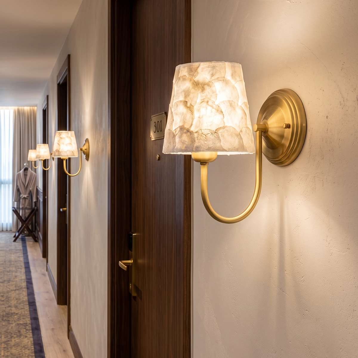 Modern Capiz Shell Wall Sconce 7 Multiple brass capiz shell wall lights illuminating a luxury hotel hallway and corridor next to room doors.
