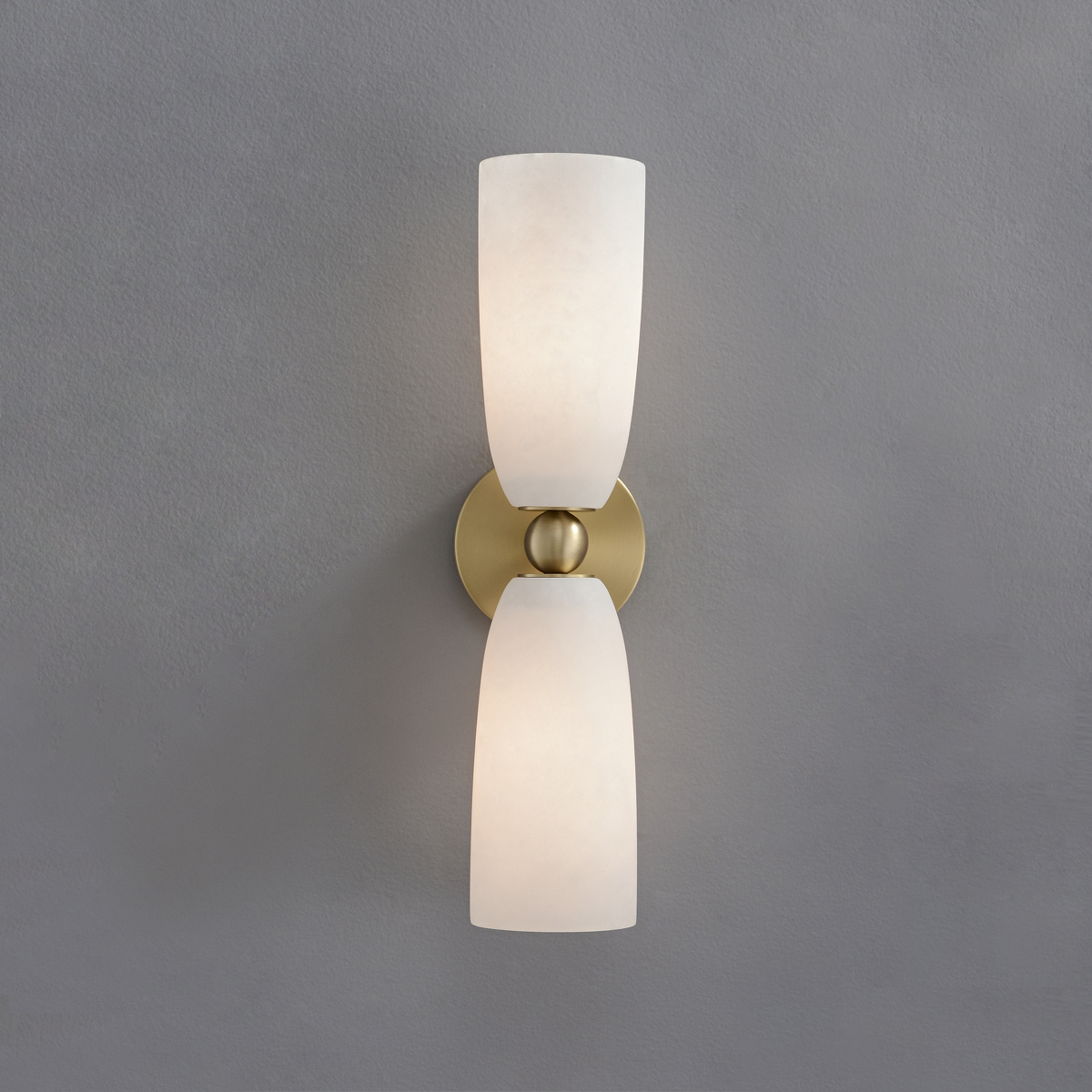 Modern Brass Frosted Glass Wall Sconce 2 Front view of a mid-century modern gold double vanity light mounted on a grey wall