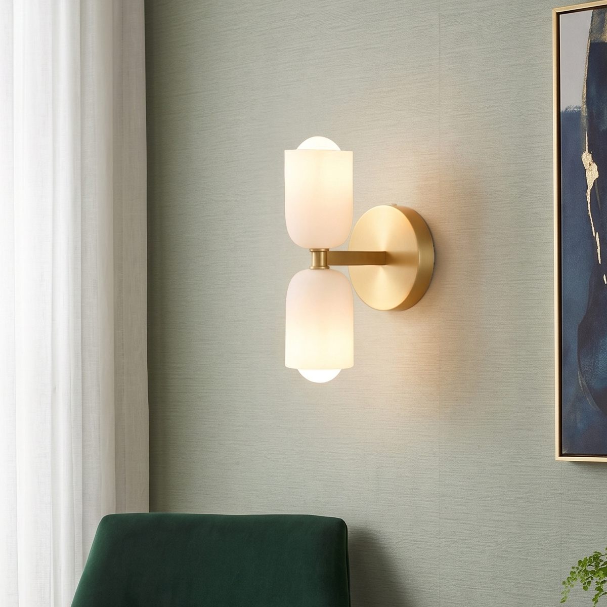 Mid-Century Modern Brass Wall Sconce 8 Brass double wall sconce mounted on a light green textured wall above a green velvet accent chair.