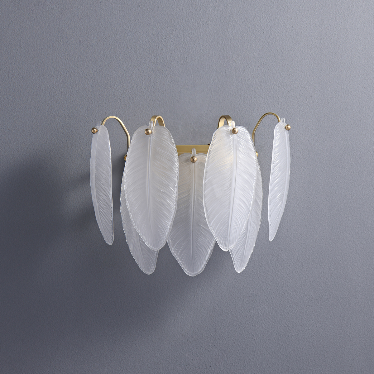 Modern Gold Leaf Glass Wall Sconce 3 Minimalist gold and glass leaf wall sconce on a grey wall
