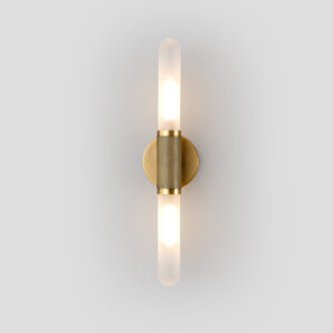 Modern brushed brass single tube wall sconce with frosted glass shades illuminated front view
